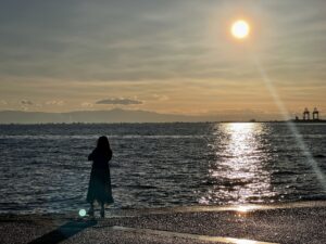 women looking out onto the sea